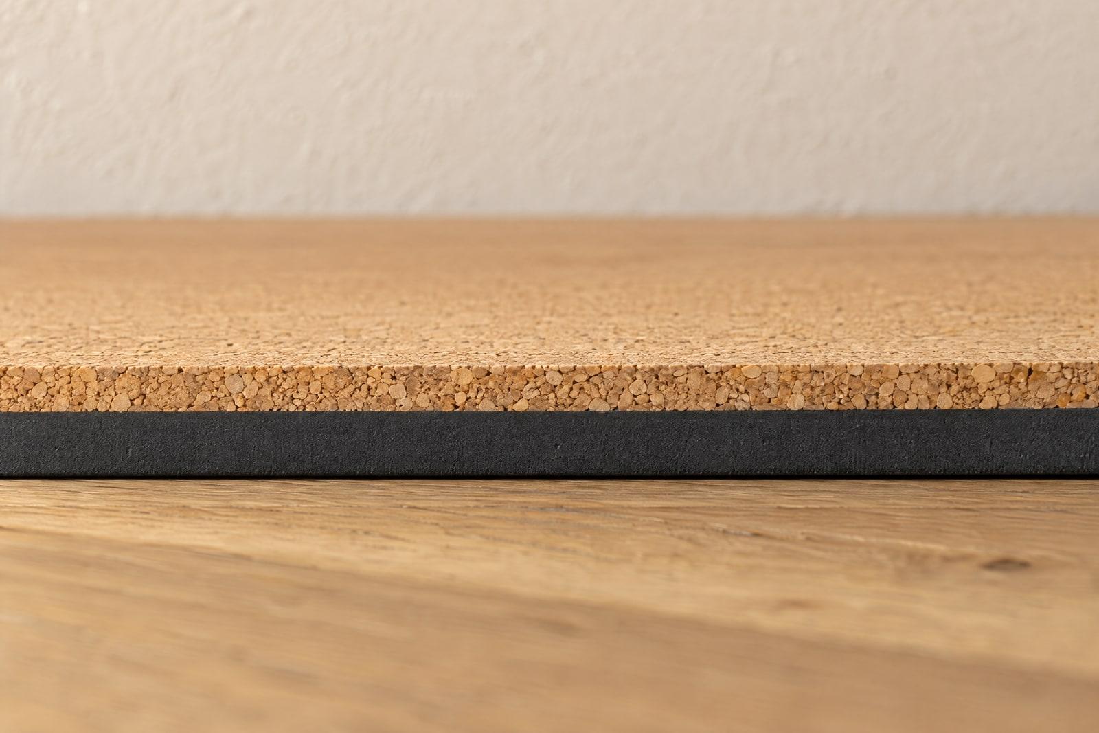 The mat's cut edge: a thin layer of cork on a thicker layer of charcoal rubber.